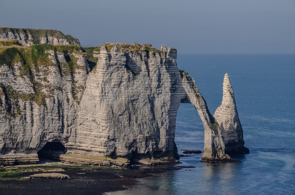 Dramatic sea cliffs and rock arches at Étretat, Normandy, France offer stunning natural beauty.